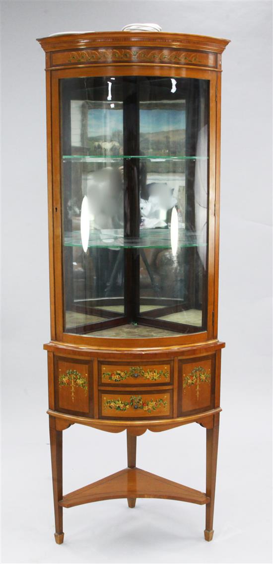 An Edwardian Sheraton Revival floral painted satinwood corner display cabinet, H.6ft